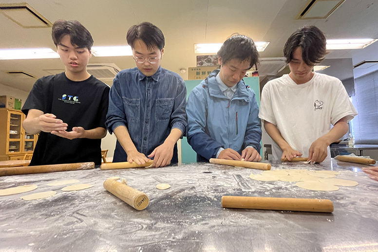 餃子の皮を伸ばしている参加者たち